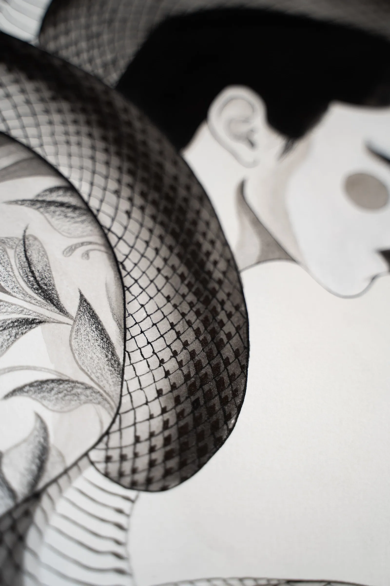 Detail: a face in profile beside a snake's coil