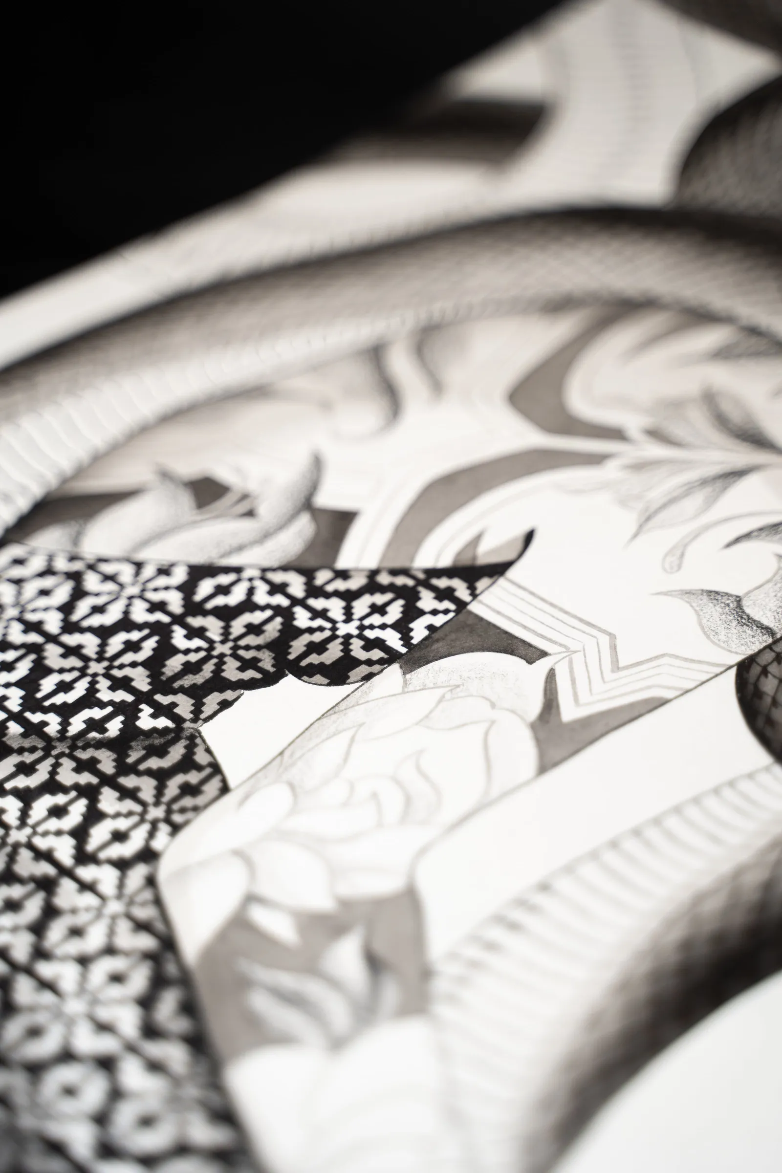 Detail: patterned scales and petals between the coils